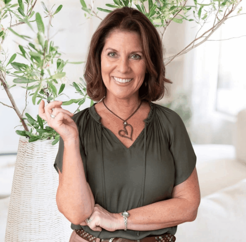 woman in green shirt, posed for head shot